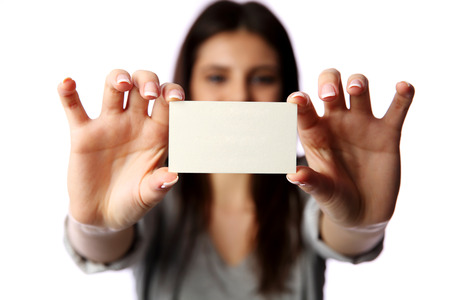 Young businesswoman holding blank business card isolated on white background