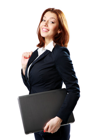 Smiling businesswoman holding laptop isolated on white backgroundの写真素材