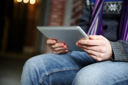 Closeup portrait of a male hands holding tablet computer