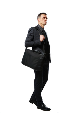 Full-length portrait of a pensive businessman with bag isolated on a white backgroundの写真素材