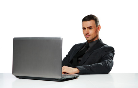 Confident businessman working on laptop isolated on a white backgroundの写真素材