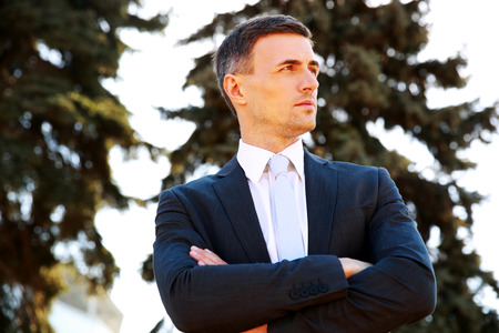 Portrait of a confident businessman standing with arms foldedの写真素材