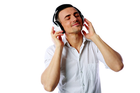 Man with headphones listening to music over white backgroundの写真素材
