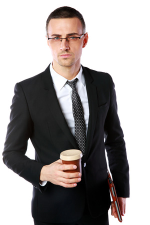Confident businessman in glasses standing with cup of coffee and tablet computer on white backgroundの写真素材