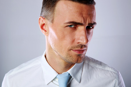 Portrait of a handsome businessman on gray backgroundの写真素材