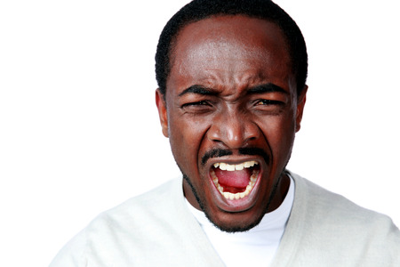 Angry african man screaming on white background