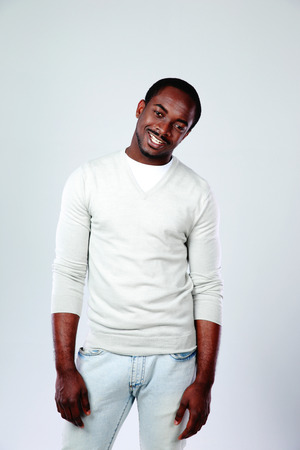 Portrait of a cheerful african man on gray backgroundの写真素材