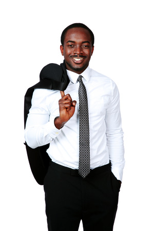 Happy african businessman stands with his jacket over his shoulderの写真素材