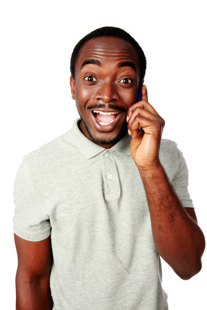 Funny african man talking on the phone isolated on a white backgroundの写真素材