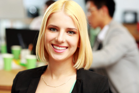 Portrait of a young happy businesswoman in officeの写真素材