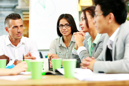 Business people having meeting around table in officeの写真素材