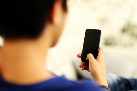 Closeup portrait of a man using smartphoneの写真素材