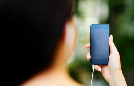 Closeup portrait of a female hand holding smartphoneの写真素材