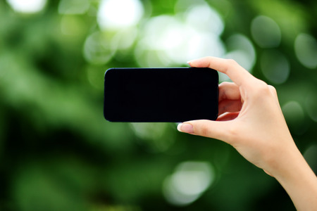 Closeup portrait of a female hands holding smartphoneの写真素材