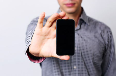 Closeup portrait of a male hands holding smartphone