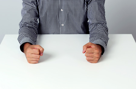 Closeup image of two fists on a white tableの写真素材