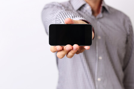 Closeup portrait of a male hand showing smartphone screen