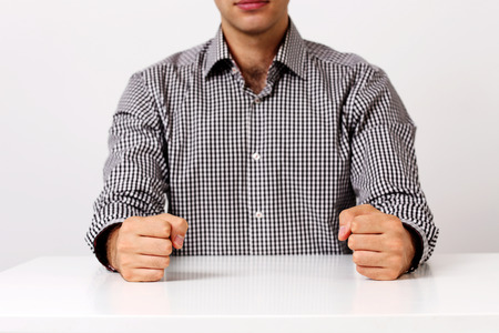 Closeup image of two fists on a white tableの写真素材