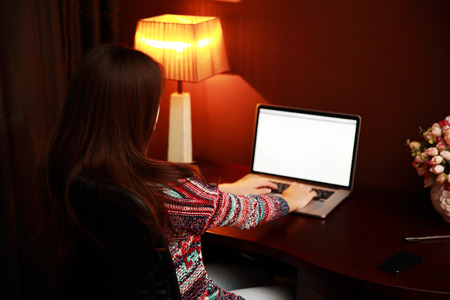 Back view portrait of a woman using laptopの写真素材