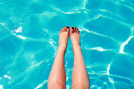 Closeup portrait of a woman's feet in a swimming poolの写真素材