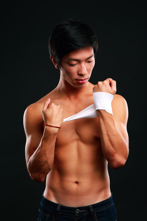 Boxer preparing for a fight bandaging his handsの写真素材