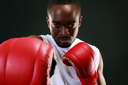 Portrait of an African American boxer punching in cameraの写真素材