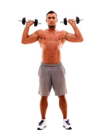 Full length portrait of a sportsman doing exercises with dumbbellsの写真素材