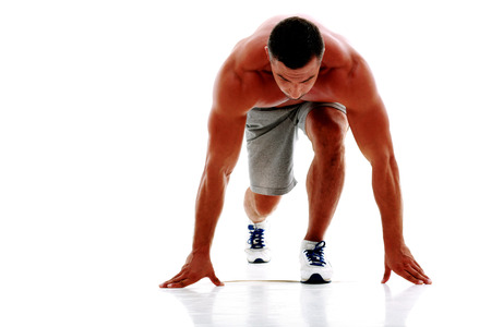 Runner in starting position over white background
