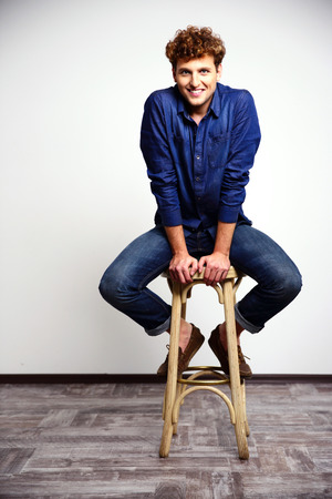 Smiling man sitting on the chairの写真素材