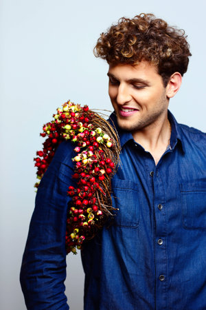 Portrait of a happy man with wreath on shoulderの写真素材