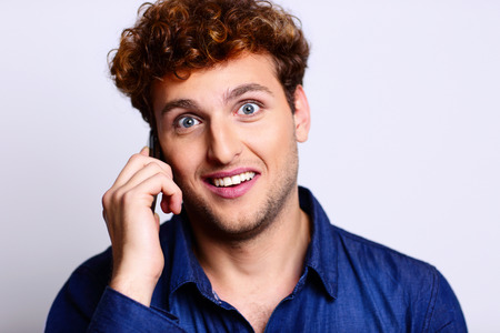 Surprised man in casual cloth talking on the phone