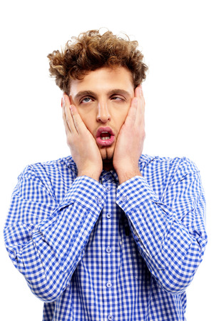 Portrait of a tired casual man over white background Portrait of a tired casual man over white background
