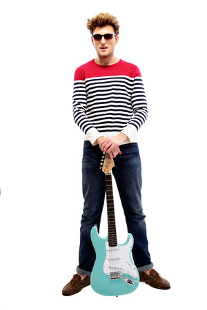 Full length portrait of a fashion man standing with guitarの写真素材