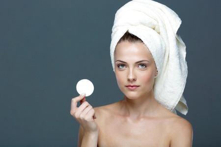 Portrait of a beautiful girl holding wadded diskの写真素材