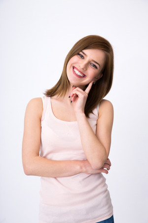 Portrait of a beautiful happy woman posing over gray backgroundの写真素材