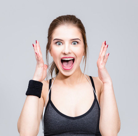 Portrait of a sports woman feel surprised facial expressionの写真素材