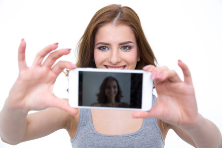 Happy woman taking selfie photo on smartphoneの写真素材