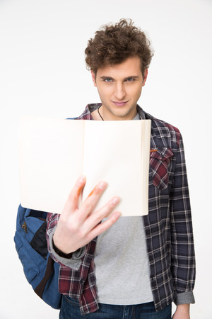 Happy young man with curly hair holding blank notebookの写真素材