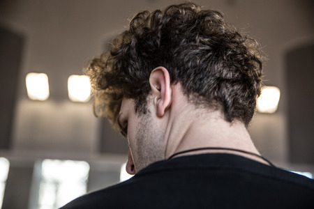 Back view portrait of a man with curly hairの写真素材