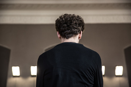 Back view portrait of a man with curly hairの写真素材