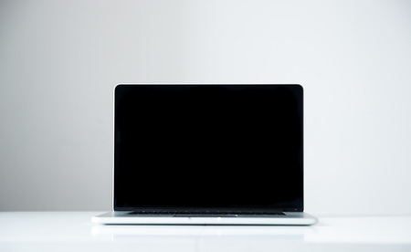 Closeup image of a laptop with blank screen on the tableの写真素材