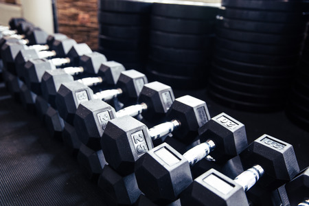 Closeup image of a dumbbells in fitness gymの写真素材