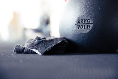 Closeup image of a kettle ball and sports glovesの写真素材