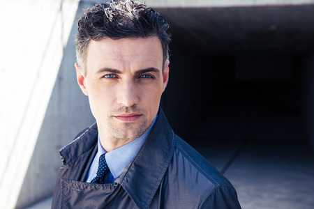 Portrait of a confident businessman standing outdoors and looking at cameraの写真素材