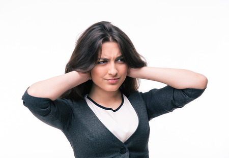 Businesswoman covering her ears with hands isolated on a white background. Looking away