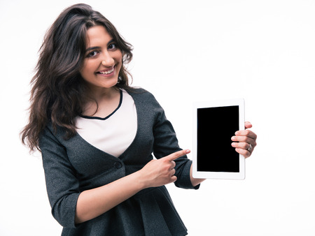 Businesswoman pointing finger on tablet computer screen isolated on a white background. Looking at cameraの写真素材