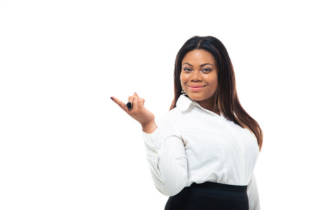 Happy afro american businesswoman pointing finger away isolated on a white background. Looking at cameraの写真素材