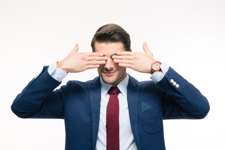 Businessman covering his eyes isolated on a white backgroundの写真素材