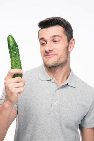 Handsome man holding cucumber isolated on a white backgroundの写真素材