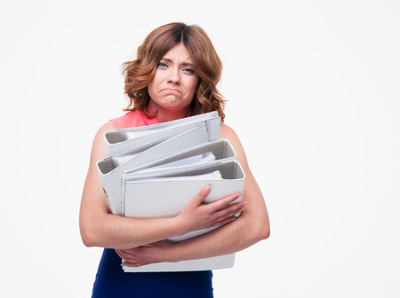 Sad businesswoman holding folders isolated on a white background. Looking at camera